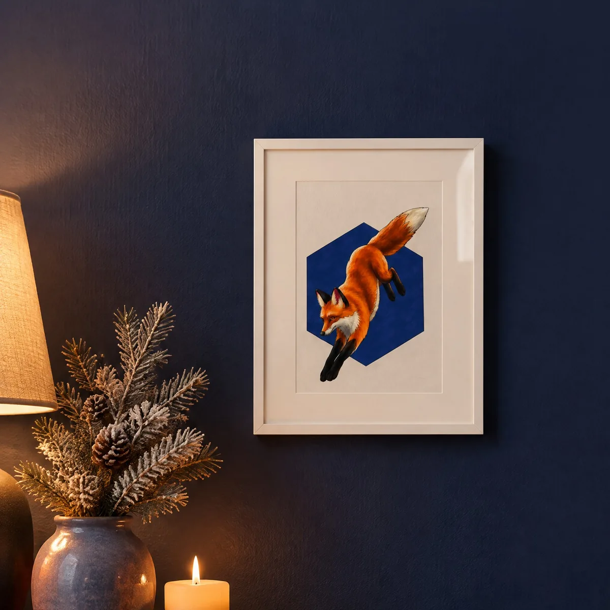 A colored red fox page in a pale frame on a dark wall, lit by a candle